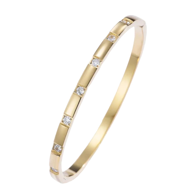 Gold bracelet with embedded diamonds on a light gray background