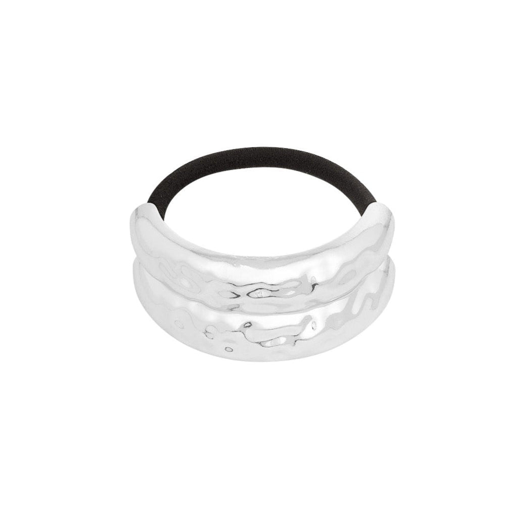 Silver hair tie with black band on a white background