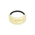 Gold hair tie with black elastic on a white background