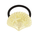 Gold shell-shaped hair tie with starfish design on a white background