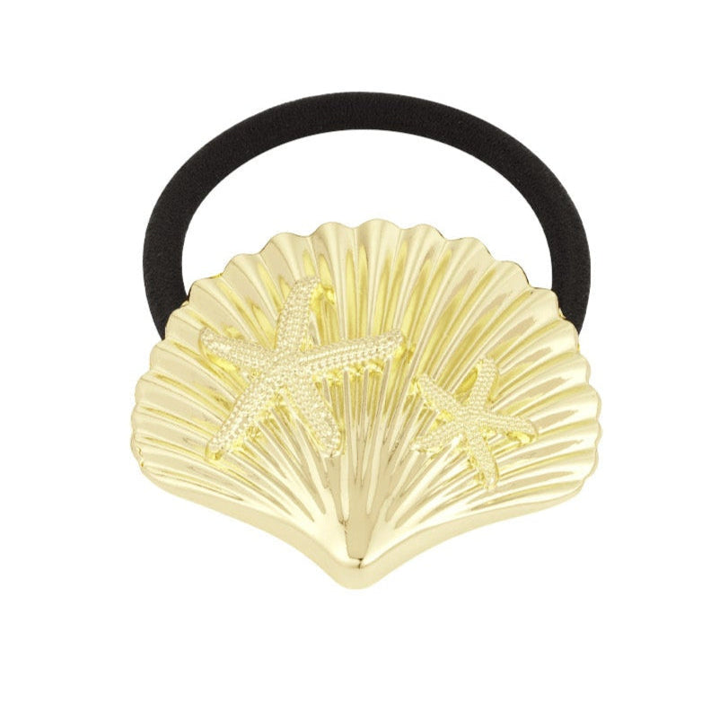Gold shell-shaped hair tie with starfish design on a white background