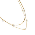Gold necklace with small pearls on a white background