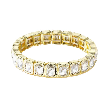 Gold bracelet with clear gemstones on a white background
