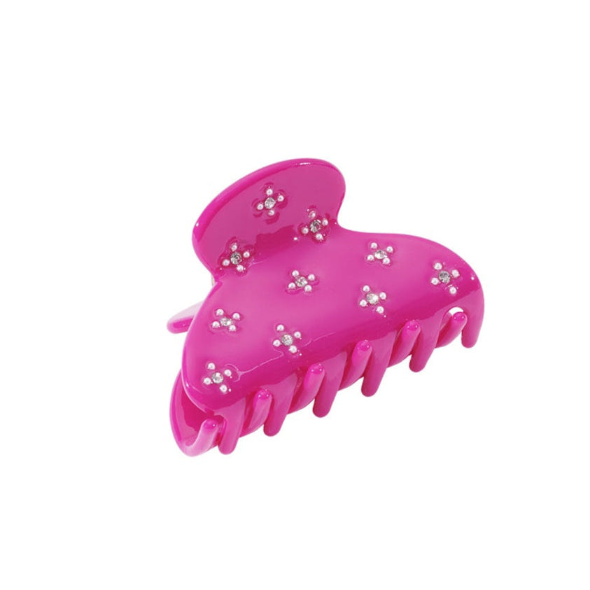 Pink hair clip with decorative elements on a white background