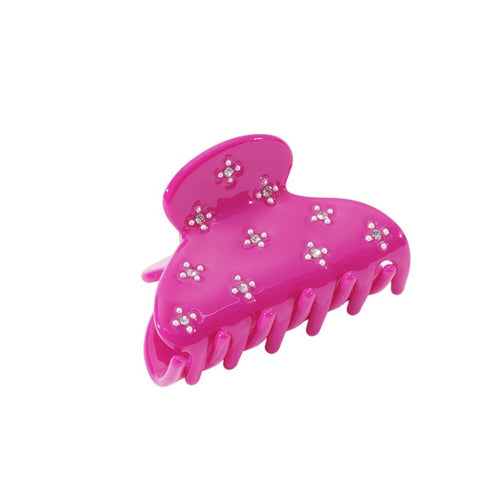 Pink hair clip with decorative elements on a white background